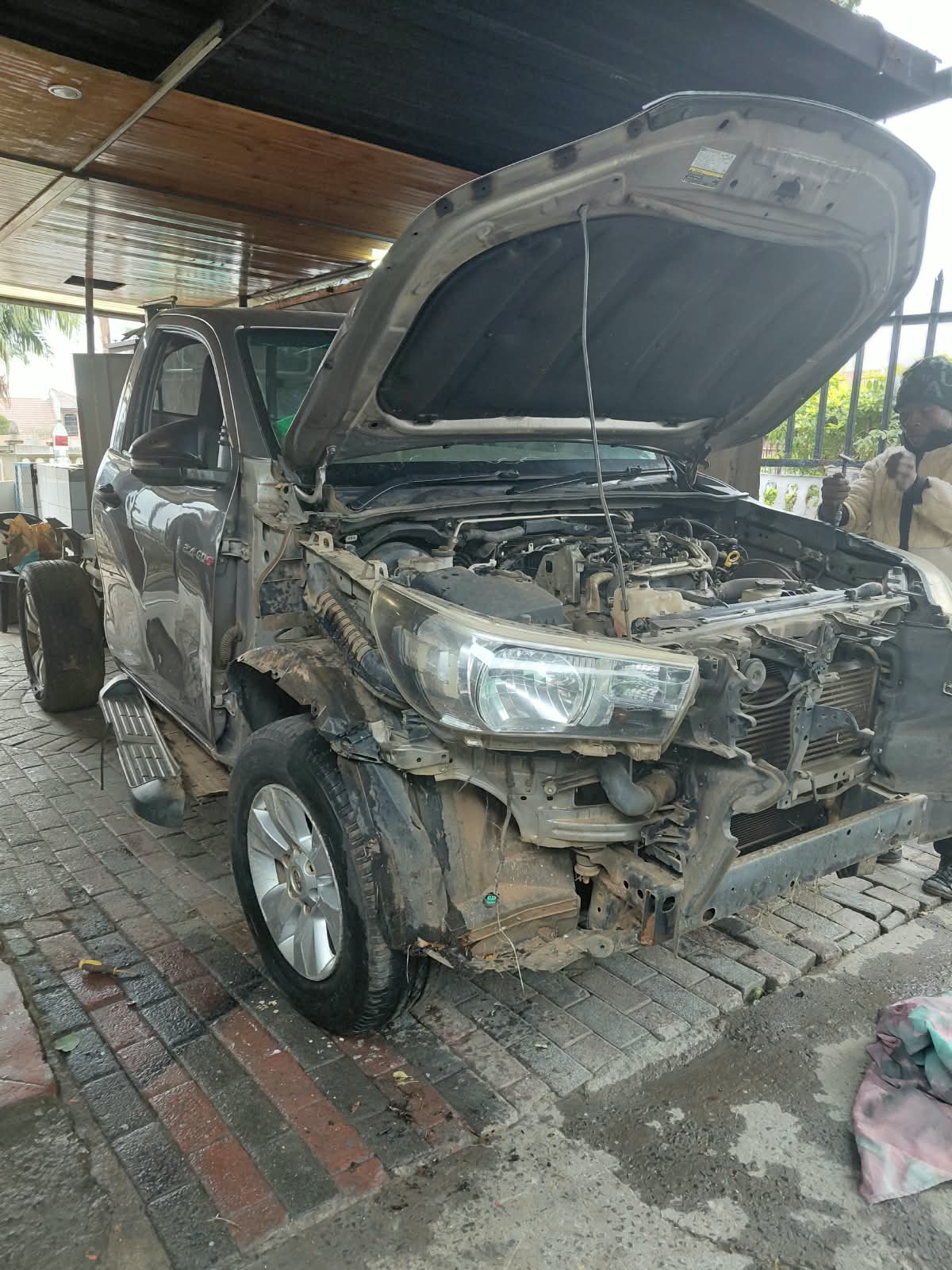 Van with the front fenders and body panels stripped for repair